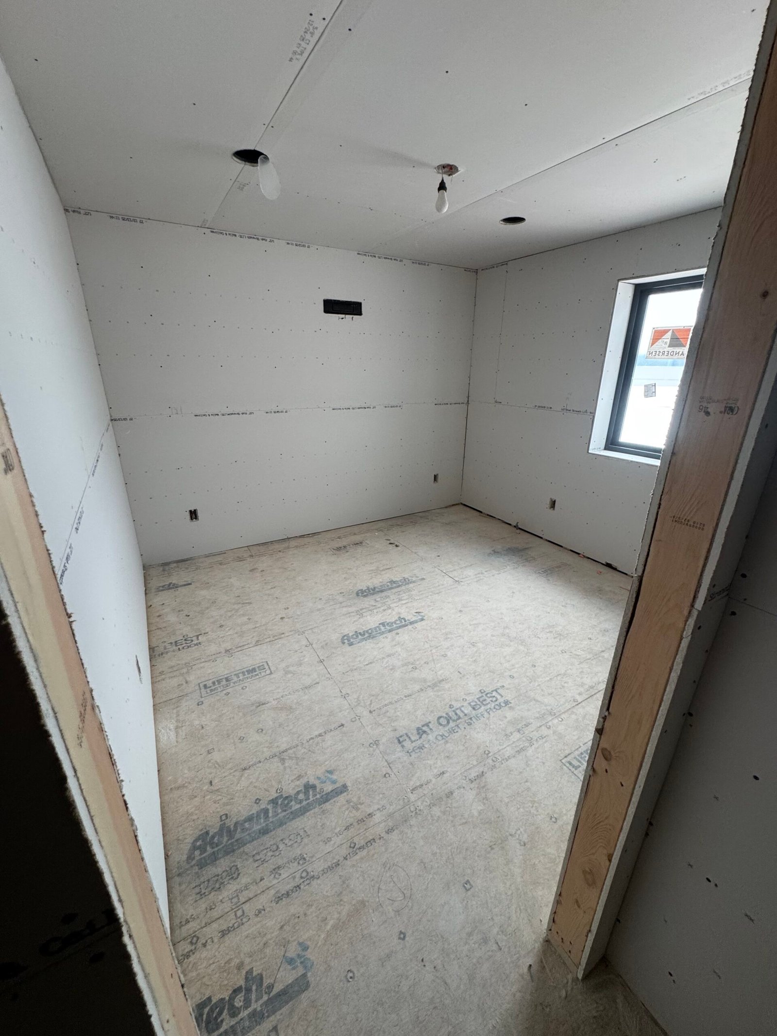 Interior drywall finisher working on a smooth wall in Minnesota